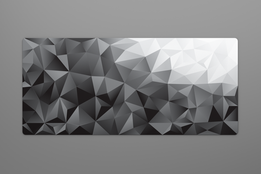Overhead shot of a large 900 by 400 millimeter mousepad with a black to white geometric gradient pattern